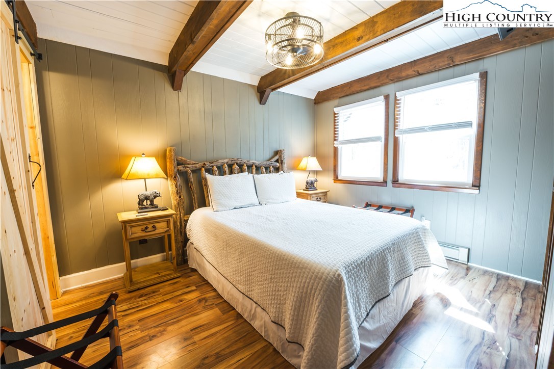 902 Pine Ridge Road Beech Mountain, NC 28604 - Photo 11 of 24 a bedroom with a bed and a window