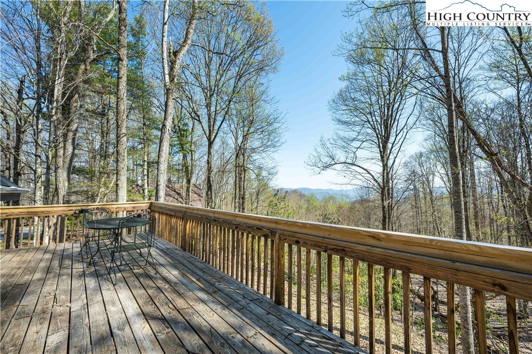902 Pine Ridge Road Beech Mountain, NC 28604 - Photo 22 of 24 a view of a balcony with wooden floor and fence