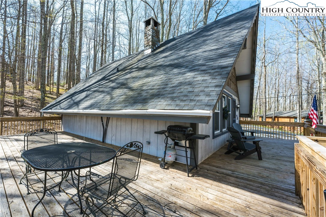 902 Pine Ridge Road Beech Mountain, NC 28604 - Photo 3 of 24 a view of balcony with chairs and wooden fence
