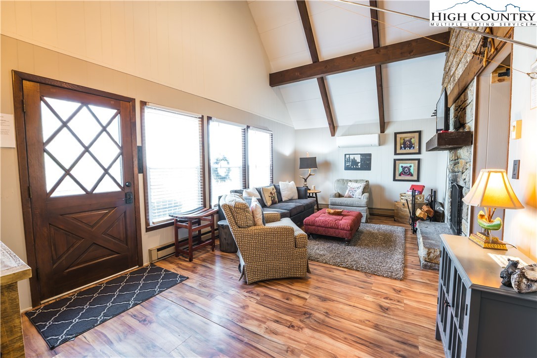 902 Pine Ridge Road Beech Mountain, NC 28604 - Photo 6 of 24 a living room with furniture or couch and a wooden floor