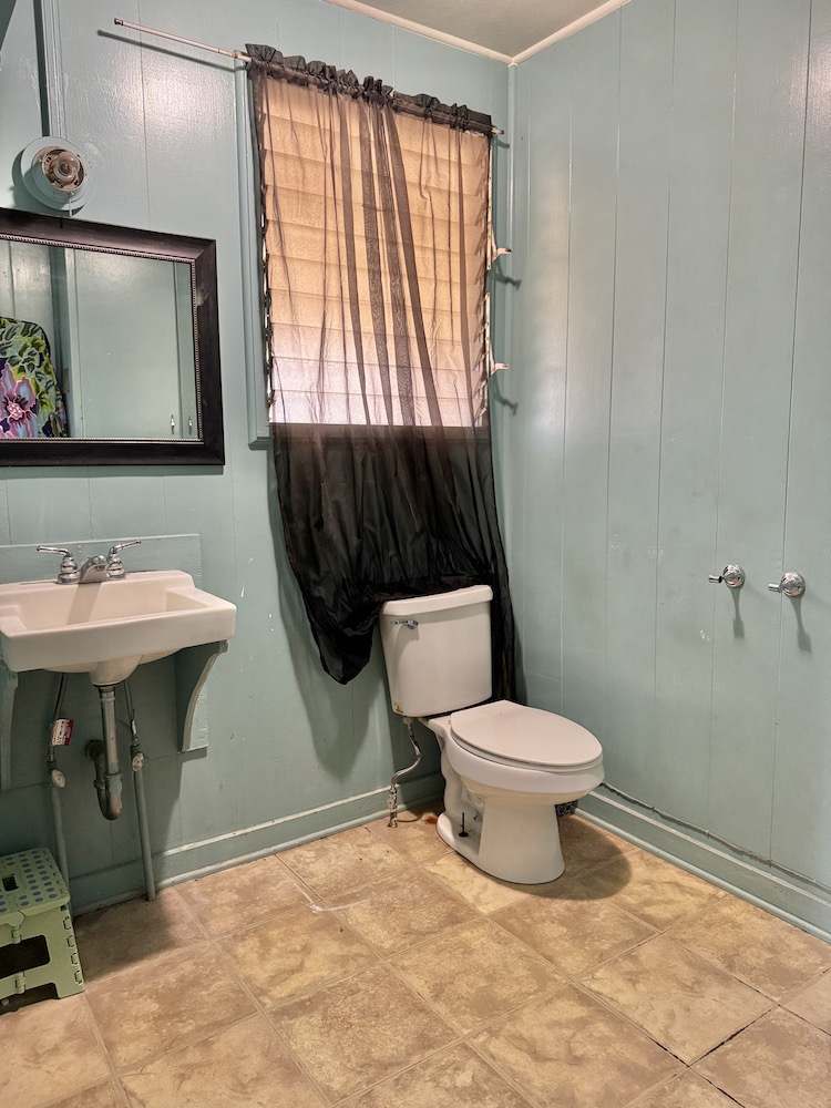 8749 Kekaha Road Kekaha, HI 96752 - Photo 8 of 16 a bathroom with a toilet sink and mirror