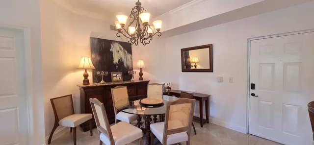 a view of a dining room with furniture and chandelier