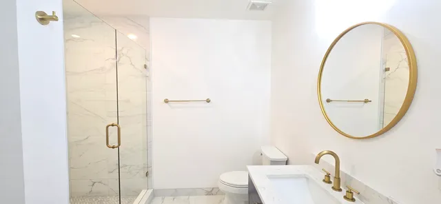 a dining room with wooden floor a chandelier a glass table and chairs