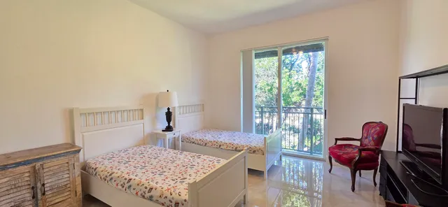 a living room with furniture ceiling fan and a window