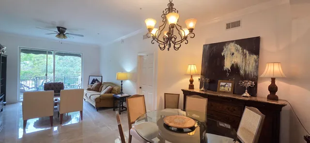 a view of a dining room with furniture and chandelier