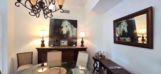 a dining room with furniture a chandelier and window