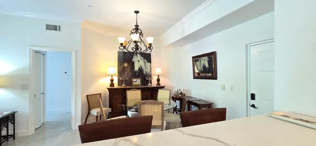 a living room with fireplace furniture and a chandelier