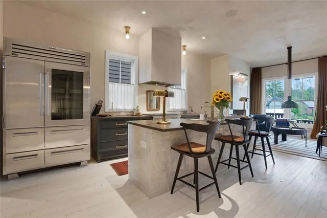 a kitchen with a dining table chairs and large window
