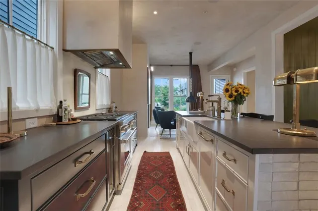 a large kitchen with stainless steel appliances a sink and a stove
