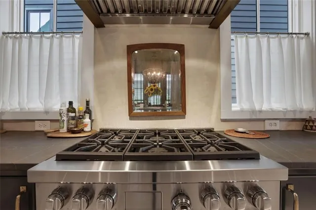 a white stove top oven sitting inside of a kitchen