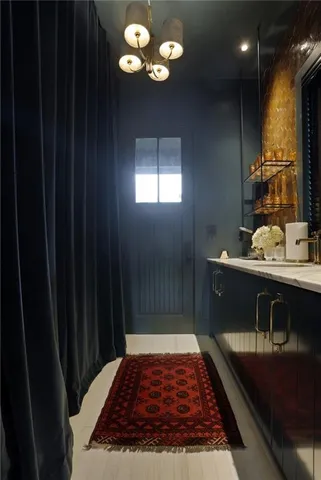 a bathroom with a bathtub a sink and a chandelier