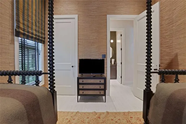 a bedroom with furniture and a flat screen tv