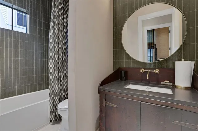 a bathroom with a sink a toilet and a mirror