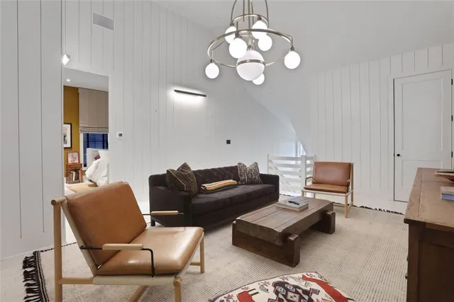 a living room with furniture wooden floor and a chandelier