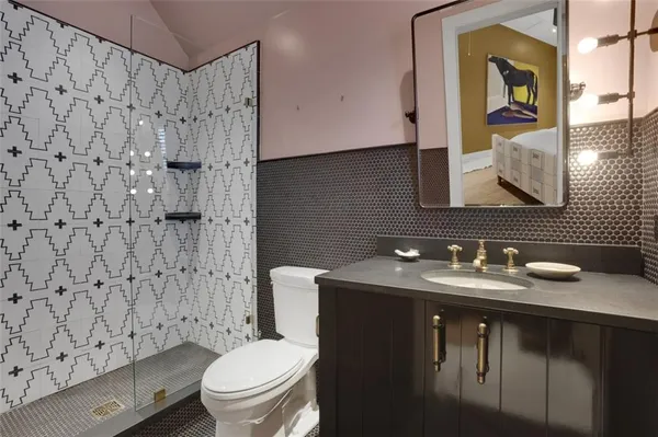 a bathroom with a sink toilet and mirror