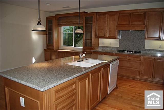 16 Riveroaks Irvine, CA 92602 - Photo 3 of 8 a kitchen with stainless steel appliances granite countertop a sink a stove and a refrigerator