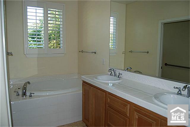 16 Riveroaks Irvine, CA 92602 - Photo 5 of 8 a bathroom with a sink and a mirror