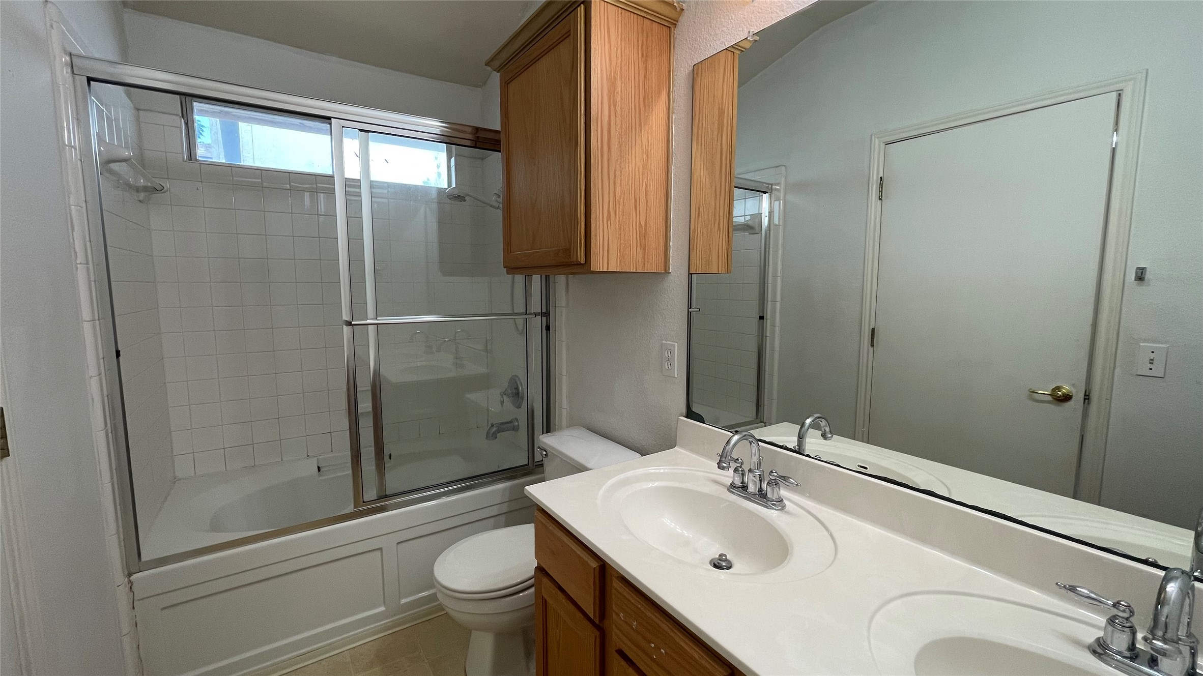 5512 Steven Creek Way Austin, TX 78721 - Photo 2 of 30 Bathroom featuring bath / shower combo with glass door and a sink