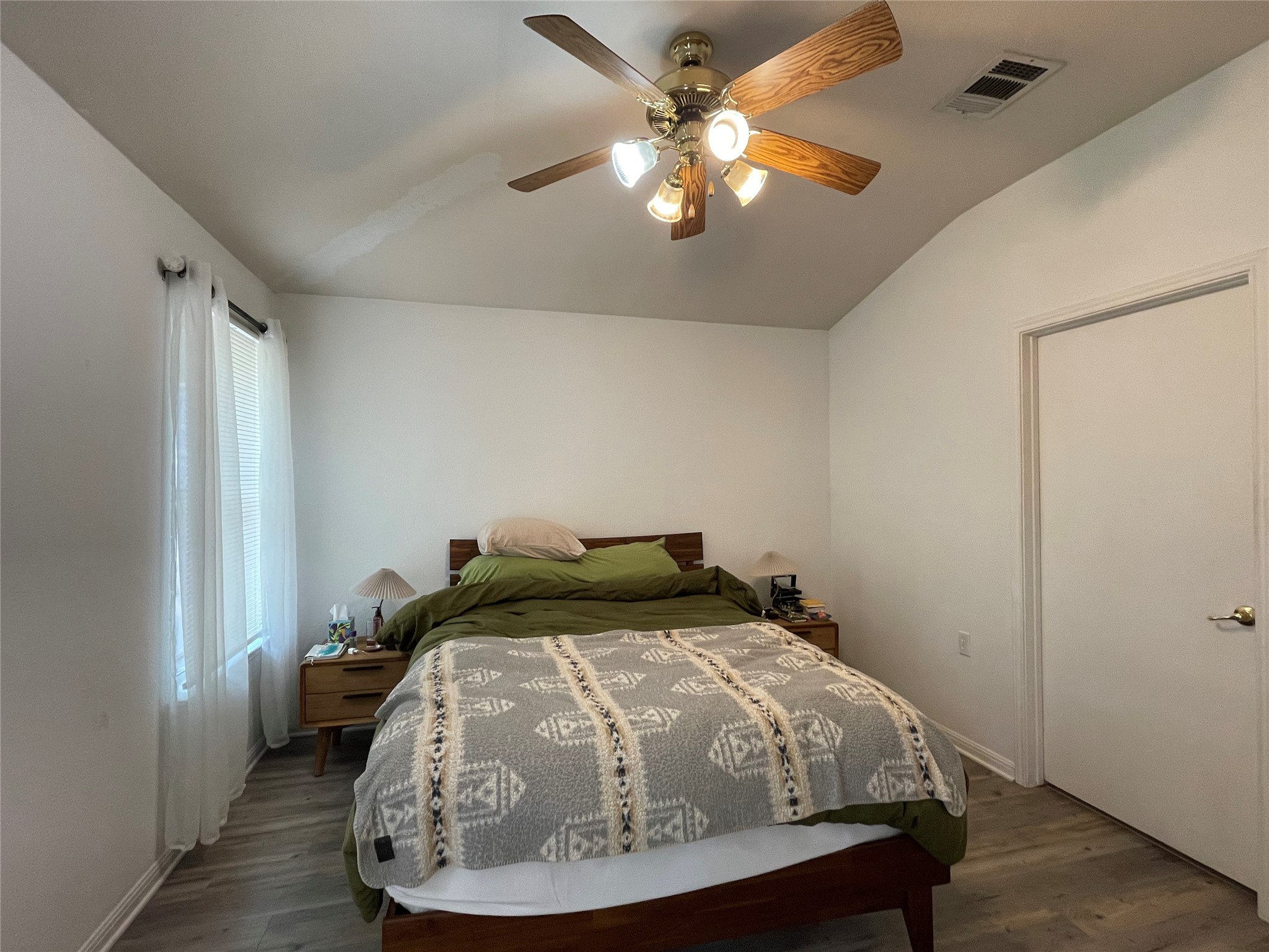 5512 Steven Creek Way Austin, TX 78721 - Photo 22 of 30 Bedroom with lofted ceiling, dark wood-style flooring, and ceiling fan