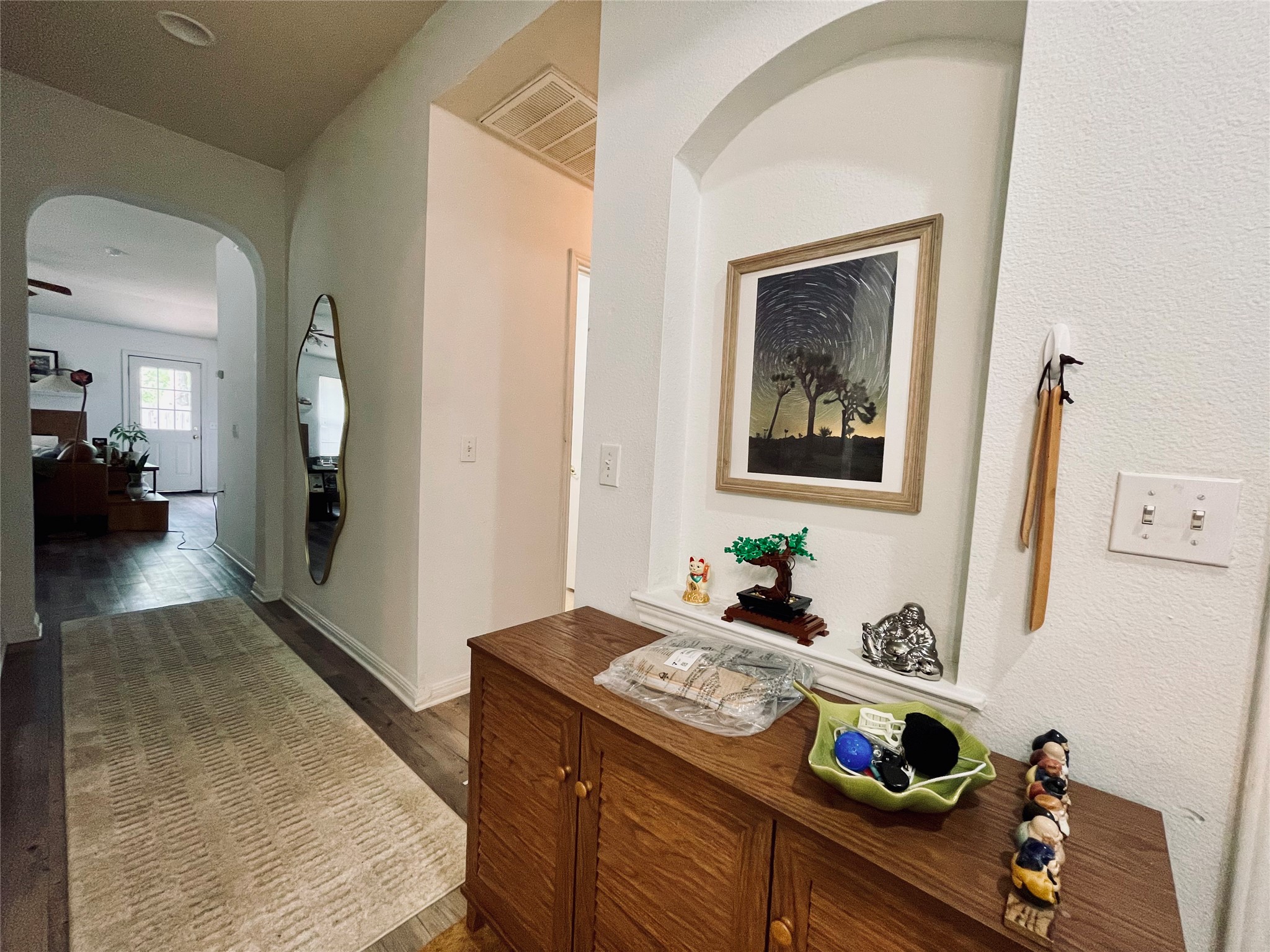 5512 Steven Creek Way Austin, TX 78721 - Photo 27 of 30 Hallway with arched walkways and dark wood-style floors