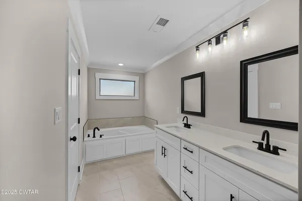 a bathroom with double sink and three mirror