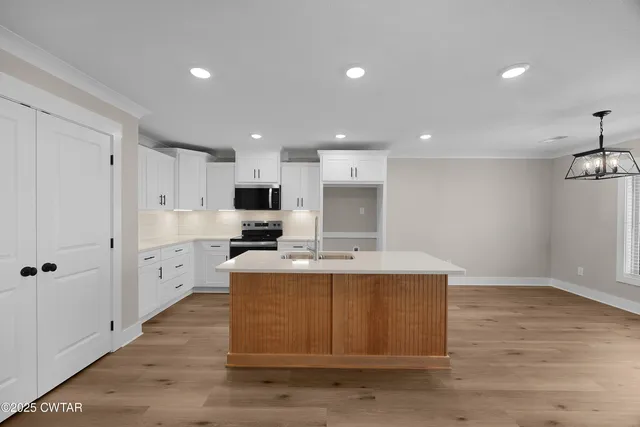 an empty room with ceiling fan and window