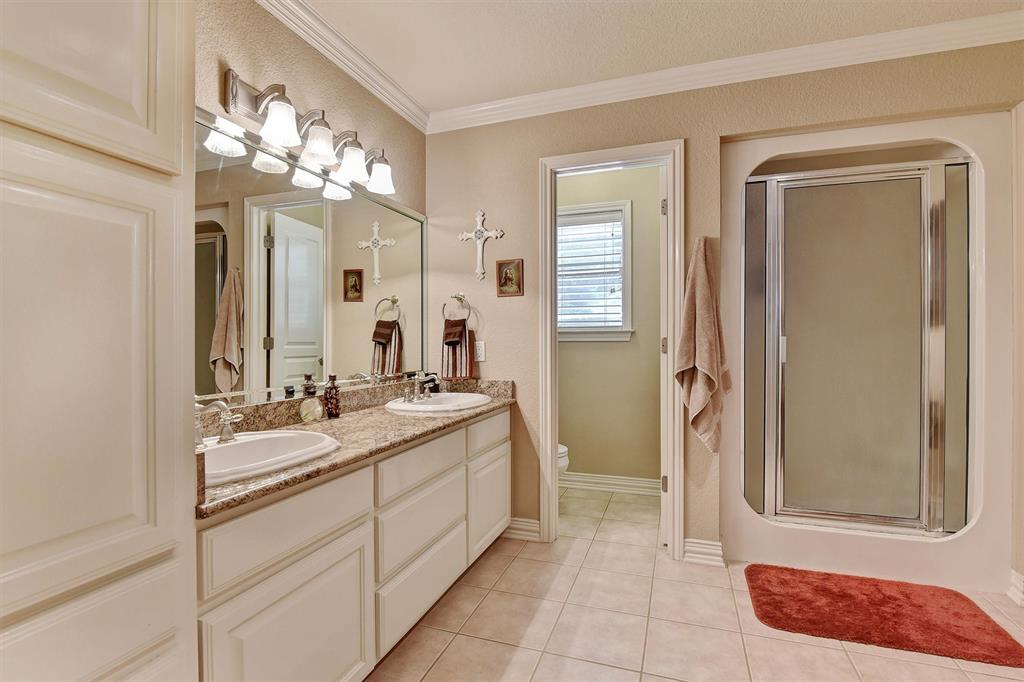 297 Cemetery Road Pottsboro, TX 75076 - Photo 20 of 40 Bathroom with tile patterned flooring, vanity, toilet, and an enclosed shower