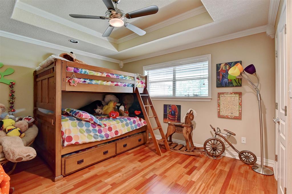 297 Cemetery Road Pottsboro, TX 75076 - Photo 23 of 40 Bedroom with a raised ceiling, ceiling fan, and crown molding