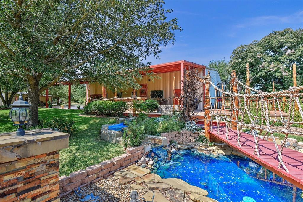 297 Cemetery Road Pottsboro, TX 75076 - Photo 37 of 40 View of Rope Bridge over water feature leading to firepit from Party Barn