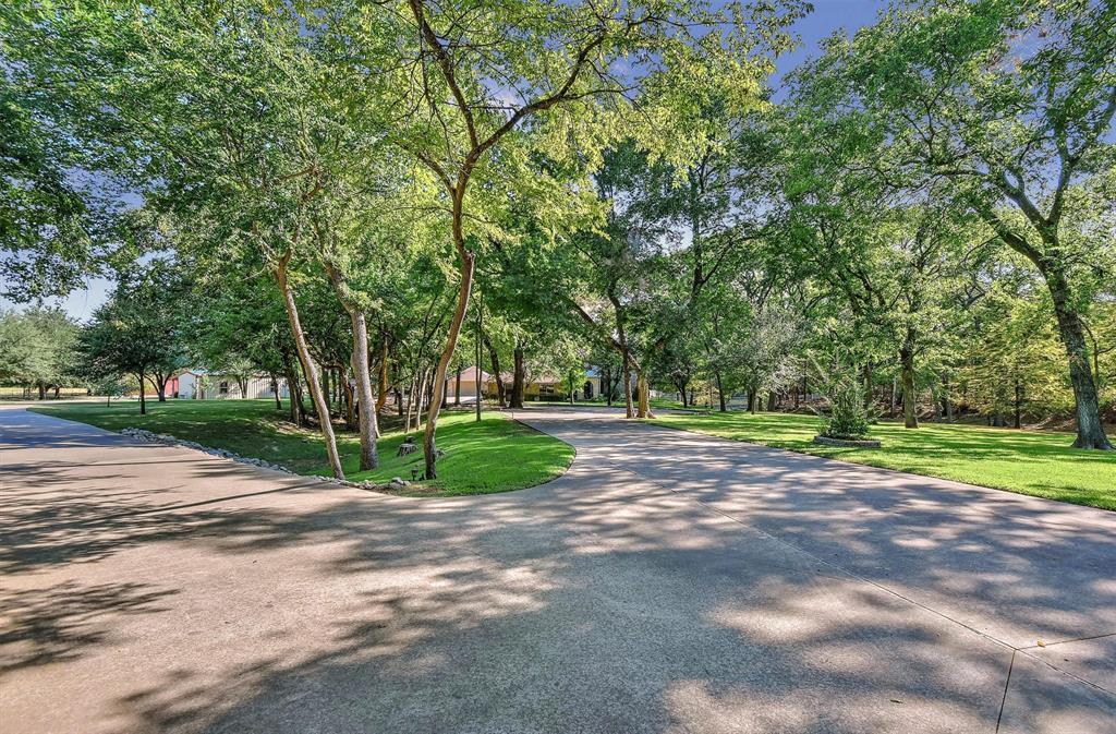 297 Cemetery Road Pottsboro, TX 75076 - Photo 4 of 40 wrap around driveway approaching house and storage metal building