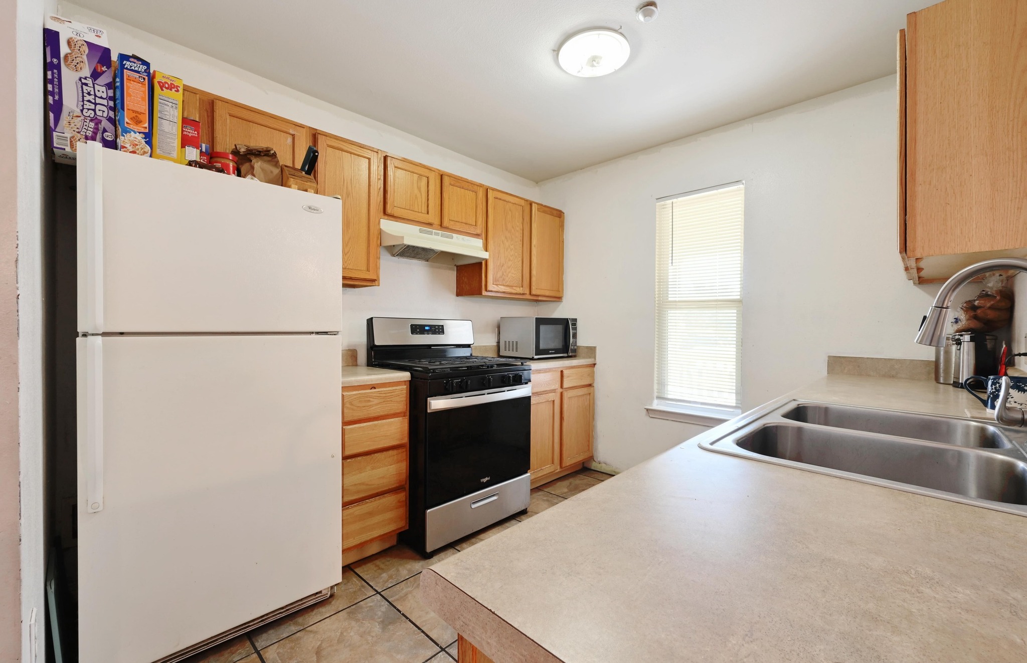6901 Frontera Trail Austin, TX 78741 - Photo 11 of 21 a kitchen with stainless steel appliances granite countertop a refrigerator a sink a stove a microwave and a refrigerator
