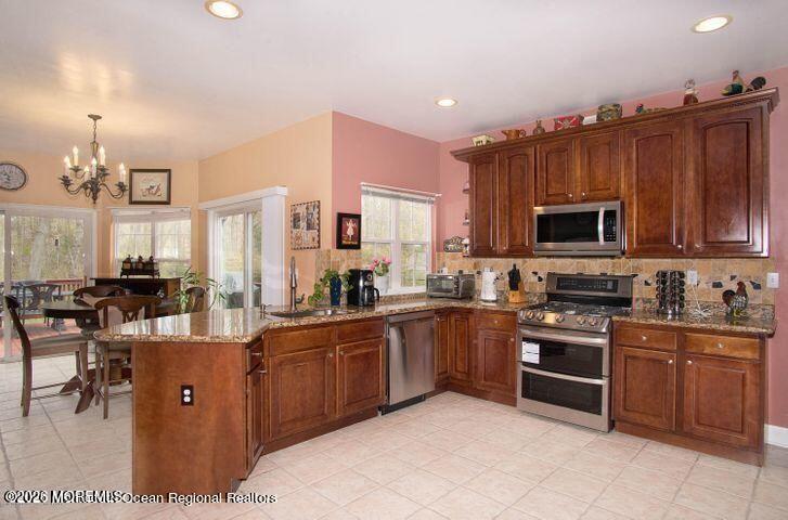 467 Leesville Road Jackson, NJ 08527 - Photo 8 of 19 a large kitchen with cabinets chairs and stainless steel appliances
