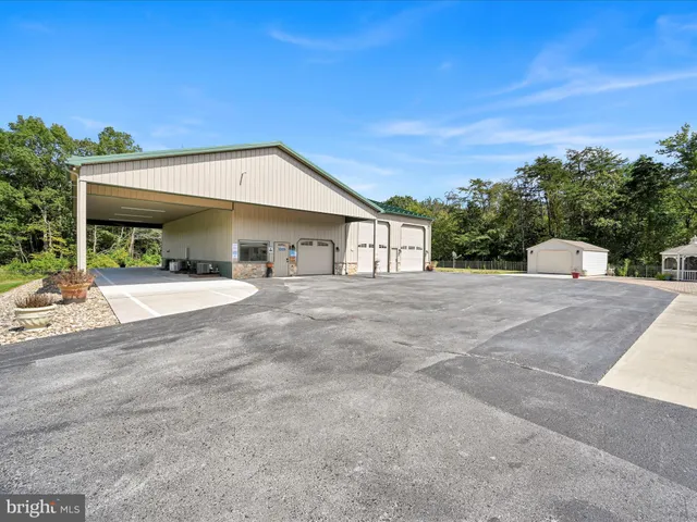 a large house with a big yard and large trees
