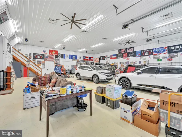 an aerial view of a house with a garden and lake view