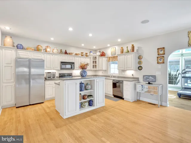 a kitchen with stainless steel appliances a refrigerator sink and stove