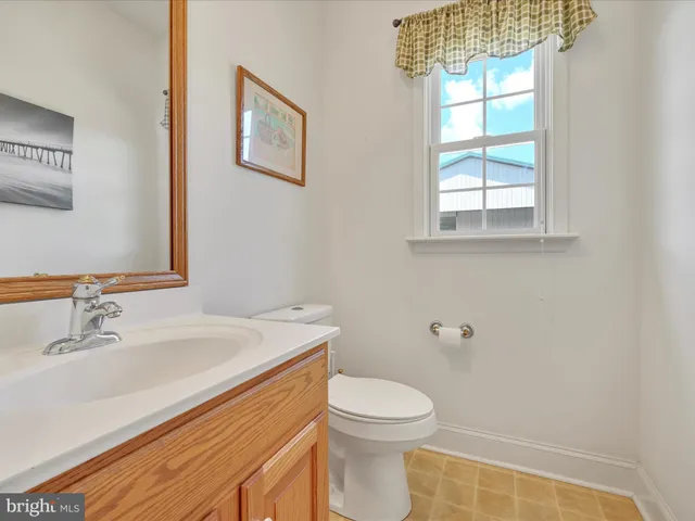 a dining room with a large window and chandelier