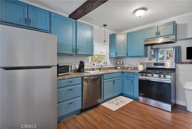 a kitchen with a sink stove and refrigerator