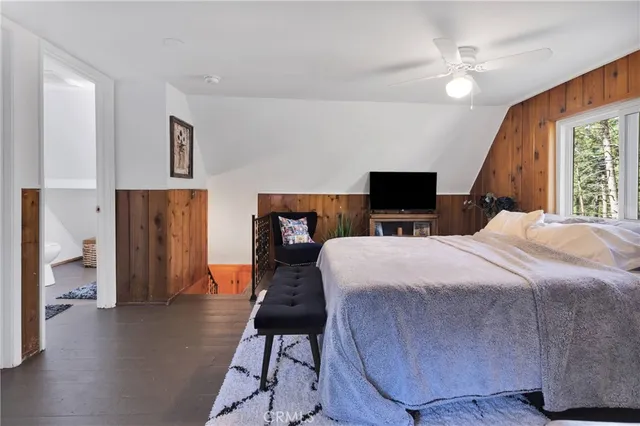 a bedroom with bed and tv