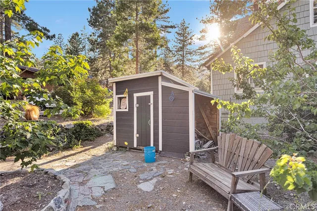 a view of a house with a yard and furniture