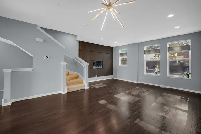 a kitchen with stainless steel appliances granite countertop a stove a sink dishwasher and a microwave oven with wooden floor