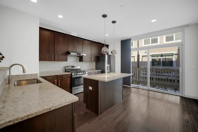 a kitchen with a sink and a refrigerator