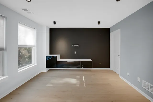 a view of a brick house with iron fence