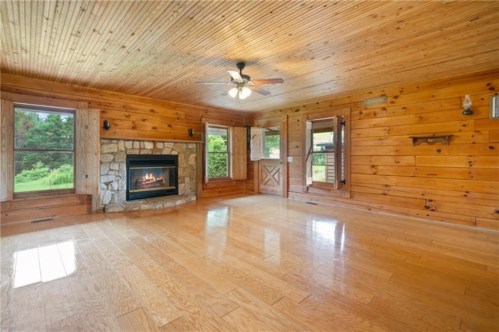 315 Woody Road Northwest Adairsville, GA 30103 - Photo 15 of 50 an empty room with fireplace chandelier and windows