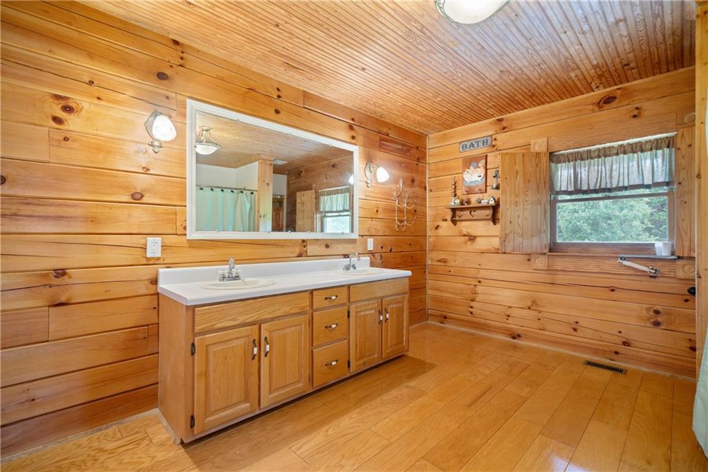 315 Woody Road Northwest Adairsville, GA 30103 - Photo 19 of 50 a bathroom with a granite countertop sink and a large mirror