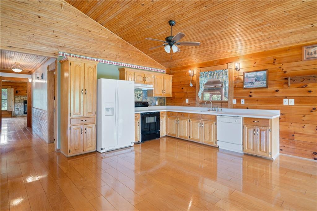 315 Woody Road Northwest Adairsville, GA 30103 - Photo 8 of 50 a large kitchen with stainless steel appliances granite countertop a stove cabinets and wooden floor