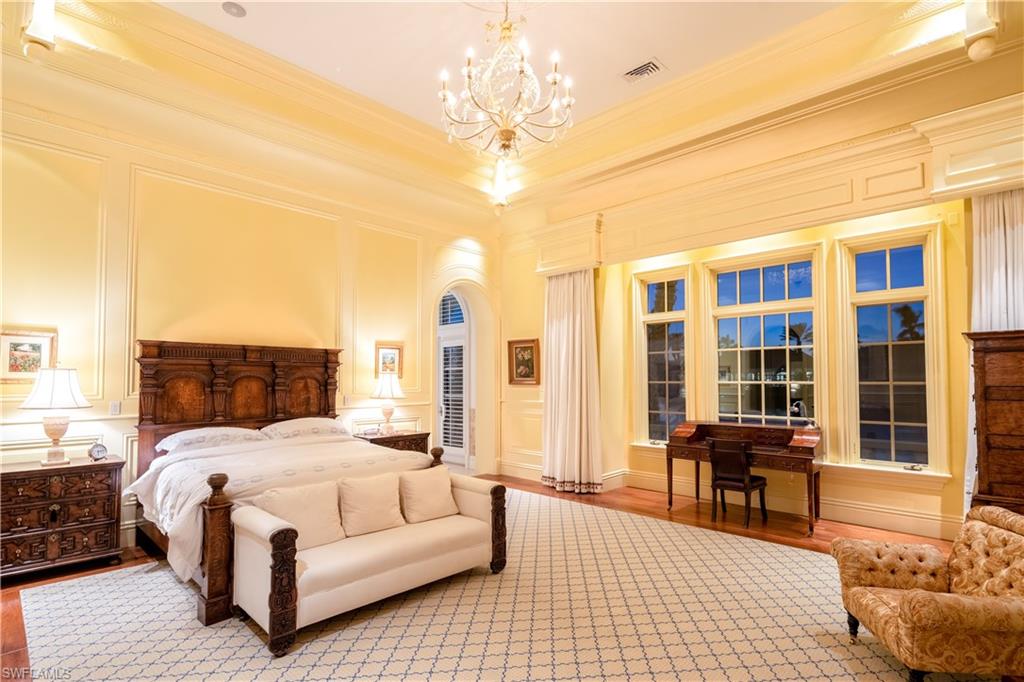 3600 Rum Row Naples, FL 34102 - Photo 12 of 20 a bedroom with a bed and wooden floor