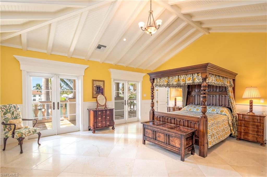 3600 Rum Row Naples, FL 34102 - Photo 14 of 20 a bedroom with a bed couch and large windows