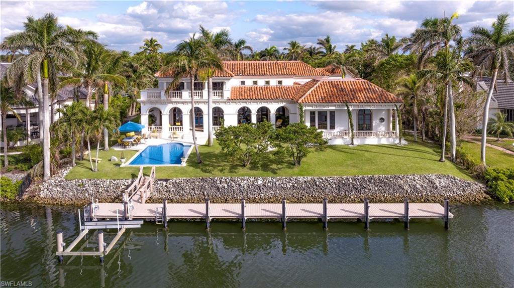 3600 Rum Row Naples, FL 34102 - Photo 17 of 20 a view of a chairs and table in the patio next to a yard