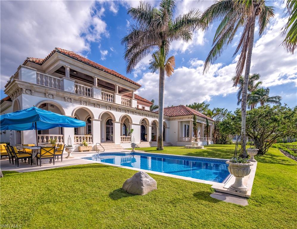3600 Rum Row Naples, FL 34102 - Photo 18 of 20 a front view of house with yard and outdoor seating