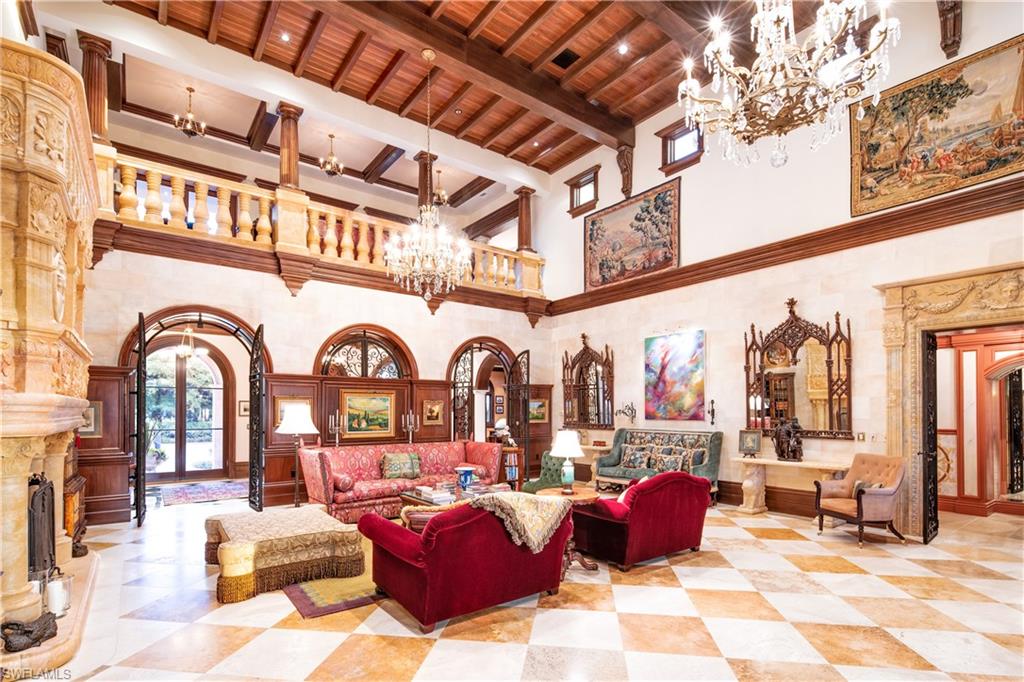 3600 Rum Row Naples, FL 34102 - Photo 7 of 20 a living room with fireplace furniture and a rug